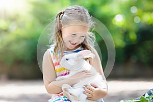 Child with rabbit. Easter bunny. Kids and pets.