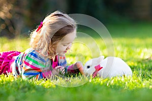 Child with rabbit. Easter bunny. Kids and pets