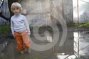 Child in rain soaked with water.