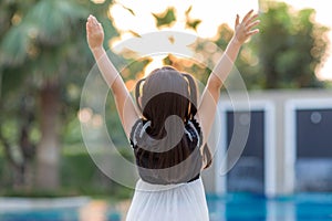 Child Raising Hands Facing Sun