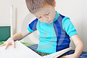 Child reading book on bed oneself learning read