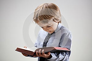 Child reading a book or bible