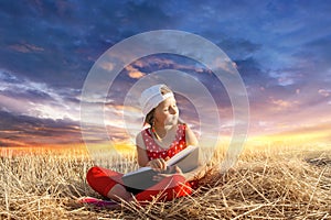 Child reading book or bible outdoors . Young Child`s Hands Praying on Holy Bible .