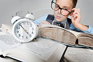 Child Reading Books behind Clock Alarm, School Boy Learning Hard Lessons, Time and Education