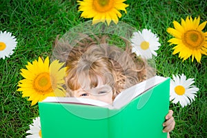 Child reading in park