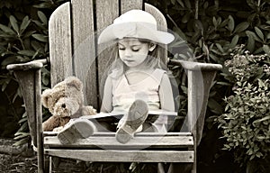 Child reading to her teddy bear