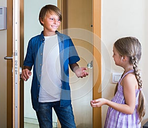 Child receiving expected friend at home interior photo