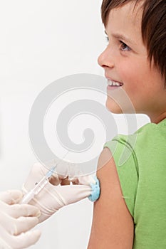Child receiving vaccine with smile on his face