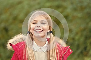 Child in red coat on idyllic autumn day