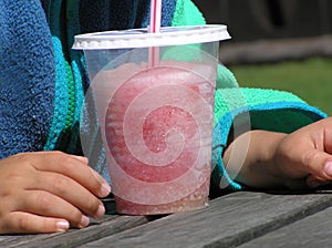 Child with red slush ice