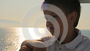 Child reflecting in the window, glass. Close-up shot of a kid looking out of the window in train. Close-up back side