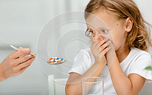 The child refuses to take medication capsules or vitamin supplements to food