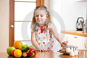 Child refusing harmful food in favor of vegetables photo