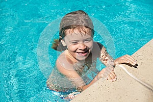 Child relax in summer swimming pool. Boy Practice Swimming.