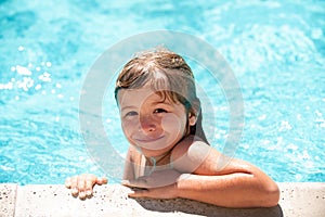 Child relax in summer swimming pool. Little boy playing in outdoor swimming pool in water on summer vacation. Child