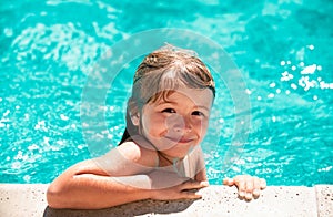 Child relax in summer swimming pool. Little boy playing in outdoor swimming pool in water on summer vacation. Child