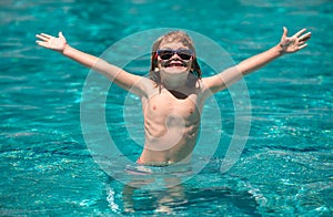 Child relax in summer swimming pool. Summertime and swimming activities for children on the pool.