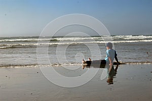 Child relaxing on beach