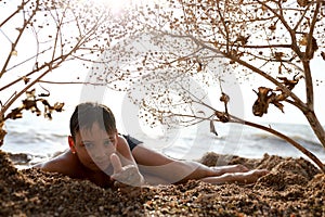 Child relaxing on beach of Azov sea photo