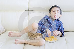 Child relaxing on the sofa with funny expression