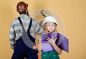 Child renovation room. Family remodeling house. Little fathers helper. Father bearded man and daughter hard hat helmet