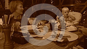 Child in restaurant, old style sepia view with grain