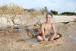 Child resting on beach of Azov sea photo