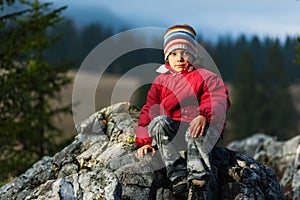 Child resting on cliff