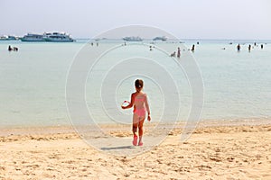 The child is resting in the summer on the sea.