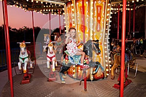 Child rides a carousel