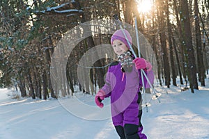 Child rides on skis. forest in winter winter ski child