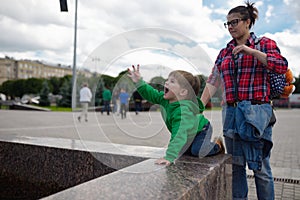 The child ridiculously looks up calling up someone