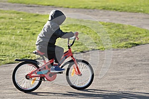 Child riding Bicycle. Boy learning to ride a bike