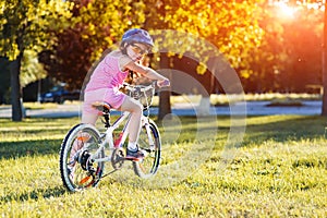 Child riding a bicycle. The kid in helmet on bike