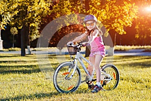 Child riding a bicycle. The kid in helmet on bike