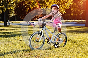 Child riding a bicycle. The kid in helmet on bike