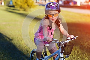 Child riding a bicycle. The kid in helmet on bike