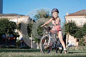 Child riding a bicycle. The kid in helmet on bike