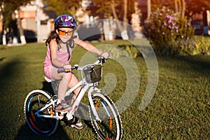 Child riding a bicycle. The kid in helmet on bike