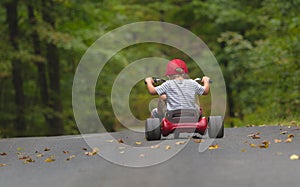 Child Riding a Big Wheel Bike