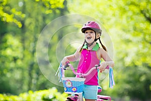 Child riding bike. Kid on bicycle.