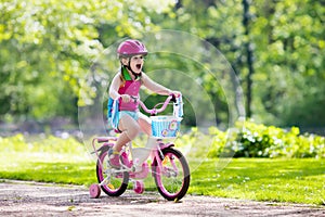 Child riding bike. Kid on bicycle.