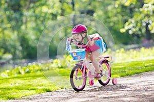 Child riding bike. Kid on bicycle.