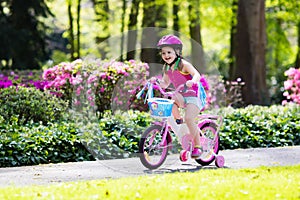 Child riding bike. Kid on bicycle.