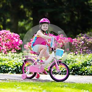 Child riding bike. Kid on bicycle.