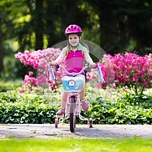 Child riding bike. Kid on bicycle.