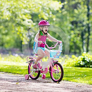 Child riding bike. Kid on bicycle.