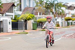 Child riding bike. Kid on bicycle in sunny park