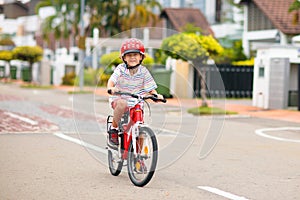 Child riding bike. Kid on bicycle in sunny park