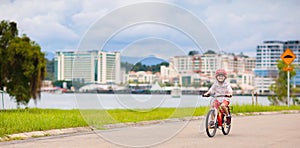 Child riding bike. Kid on bicycle in sunny park